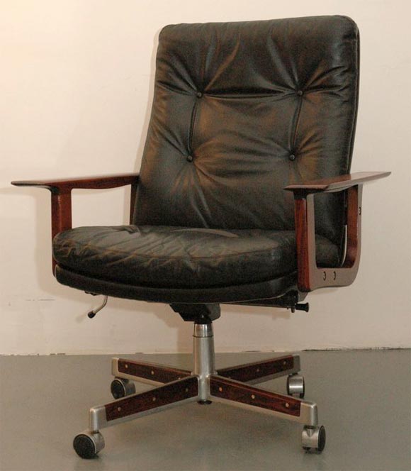 Rare Rosewood and black leather executive office chair by Arne Vodder.  Original rosewood base swivels & pivots.  Adjustable in height and an overall beauty!